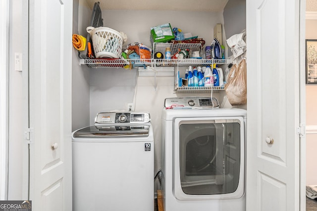 washroom featuring laundry area and separate washer and dryer