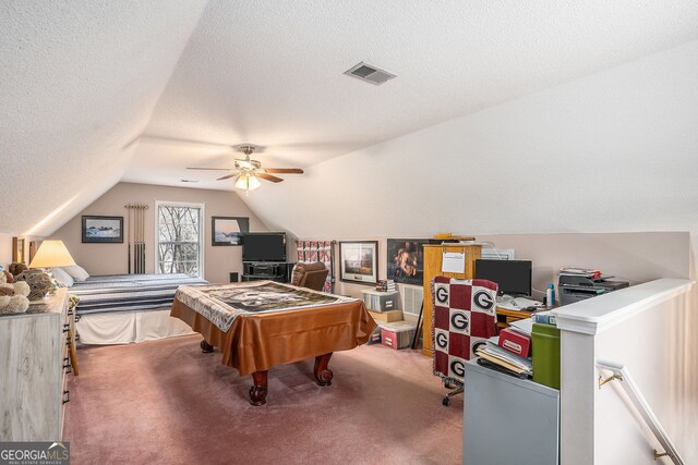 playroom featuring visible vents, a ceiling fan, a textured ceiling, carpet flooring, and lofted ceiling