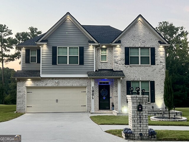 view of front of house featuring a garage, brick siding, driveway, and roof with shingles