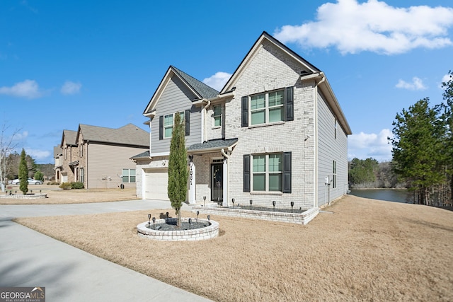 view of front of house with an attached garage, brick siding, and driveway