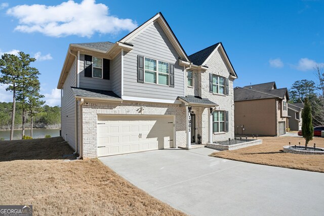 view of front facade featuring a garage, brick siding, driveway, and a shingled roof