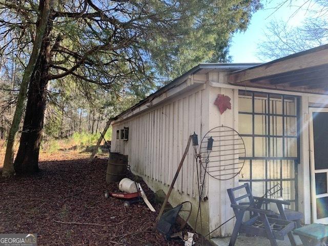 view of side of home with a sunroom