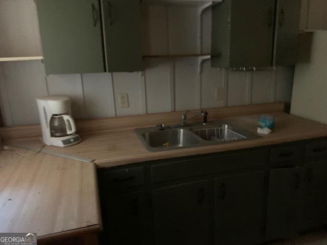 kitchen featuring light countertops and a sink