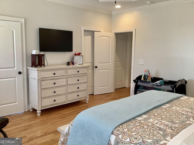 bedroom featuring light wood-type flooring and ornamental molding