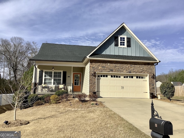 craftsman inspired home with a porch, stone siding, board and batten siding, and concrete driveway