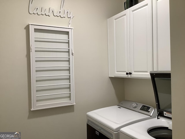 laundry area featuring washer and dryer and cabinet space