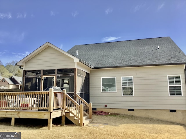 rear view of house featuring crawl space, a shingled roof, a wooden deck, and a sunroom