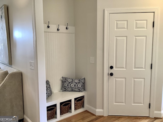 mudroom featuring wood finished floors and baseboards