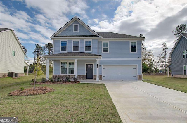 craftsman-style house featuring cooling unit, an attached garage, driveway, and a front yard