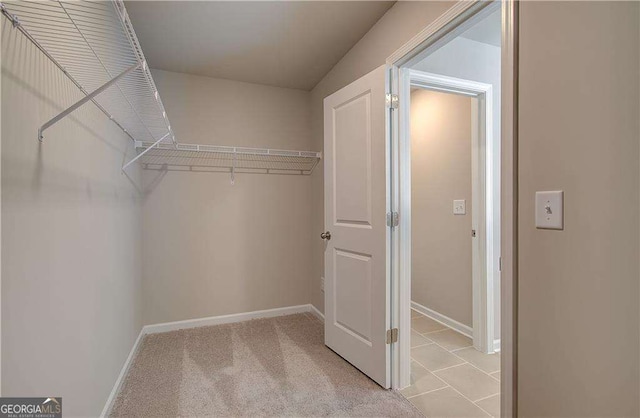 spacious closet with light colored carpet