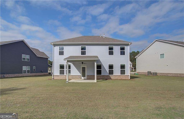 back of property with a patio area, a lawn, central AC, and brick siding