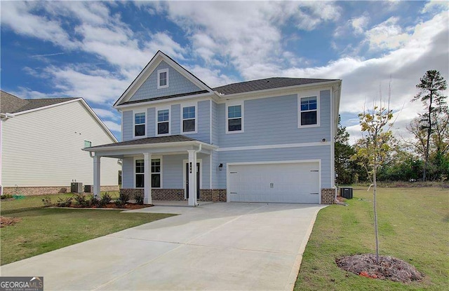 view of front of home featuring brick siding, cooling unit, an attached garage, and a front lawn