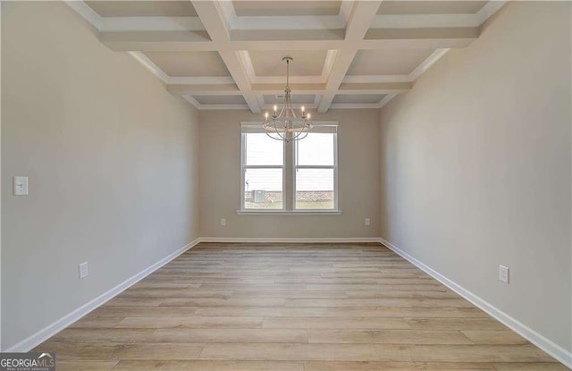 unfurnished room featuring beamed ceiling, baseboards, light wood-style floors, and an inviting chandelier