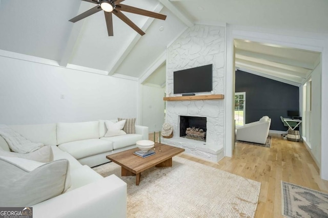 living area with a fireplace, vaulted ceiling with beams, ceiling fan, and wood finished floors