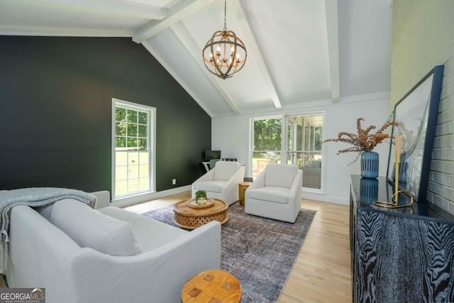 living area with a wealth of natural light, a notable chandelier, light wood-style floors, and vaulted ceiling with beams