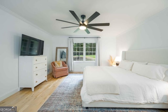 bedroom featuring a ceiling fan, crown molding, and wood finished floors