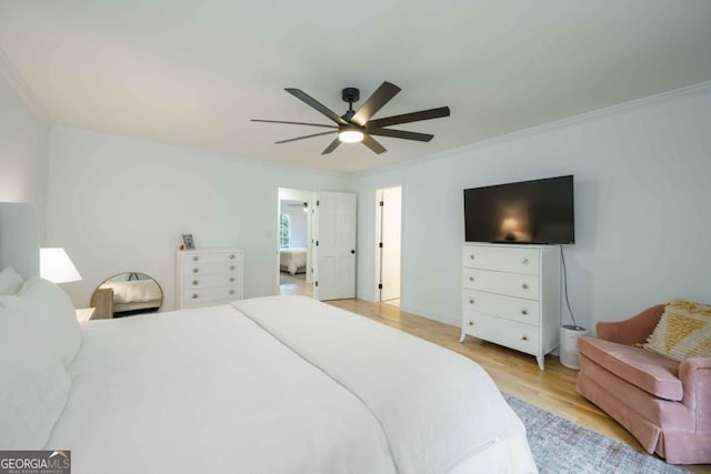 bedroom featuring ceiling fan, light wood-style flooring, and ornamental molding