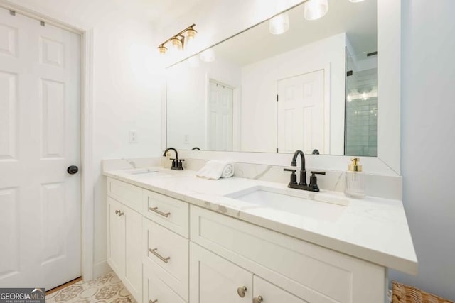 full bathroom with double vanity, an enclosed shower, and a sink