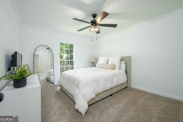 carpeted bedroom featuring a ceiling fan, baseboards, and ornamental molding