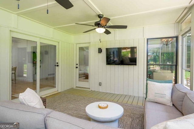 living room with a ceiling fan and wood finished floors