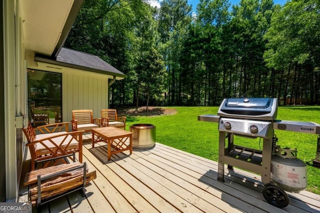 wooden terrace featuring area for grilling and a lawn