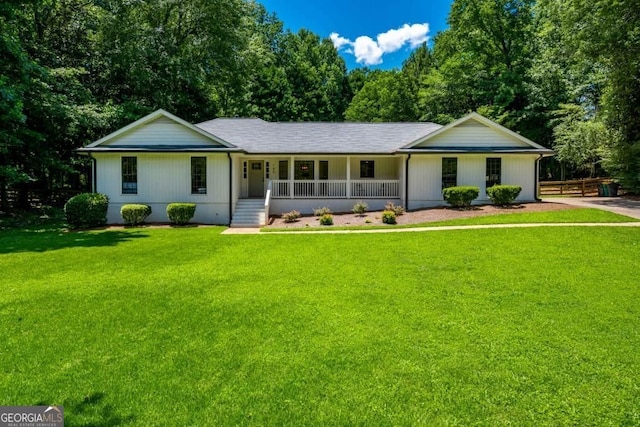 ranch-style house featuring covered porch and a front lawn