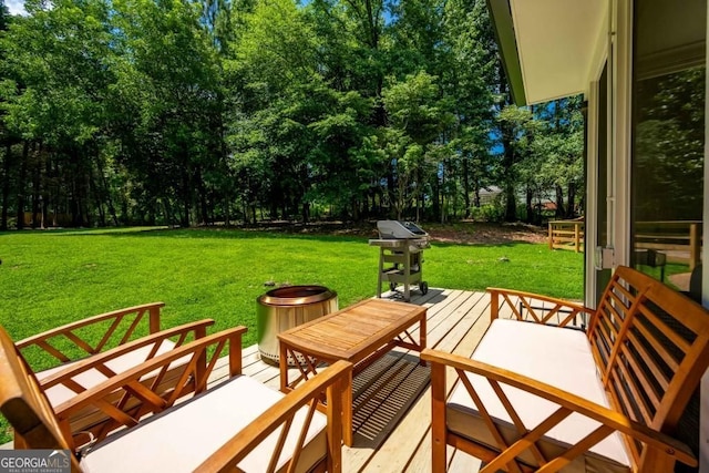 wooden deck with a grill and a yard