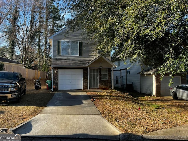 traditional-style home with brick siding, driveway, and fence