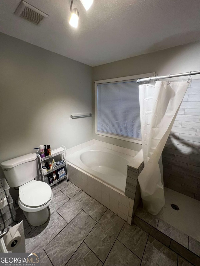 bathroom with a bath, visible vents, a stall shower, and toilet