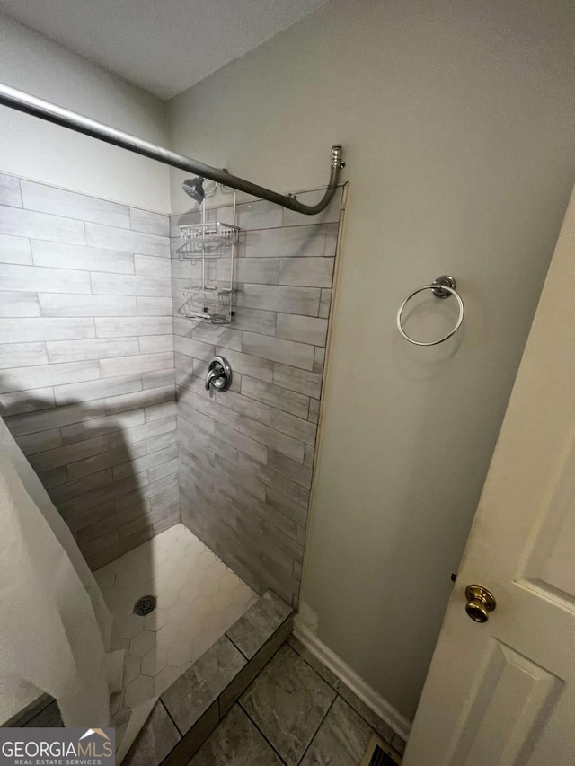 bathroom with a tile shower