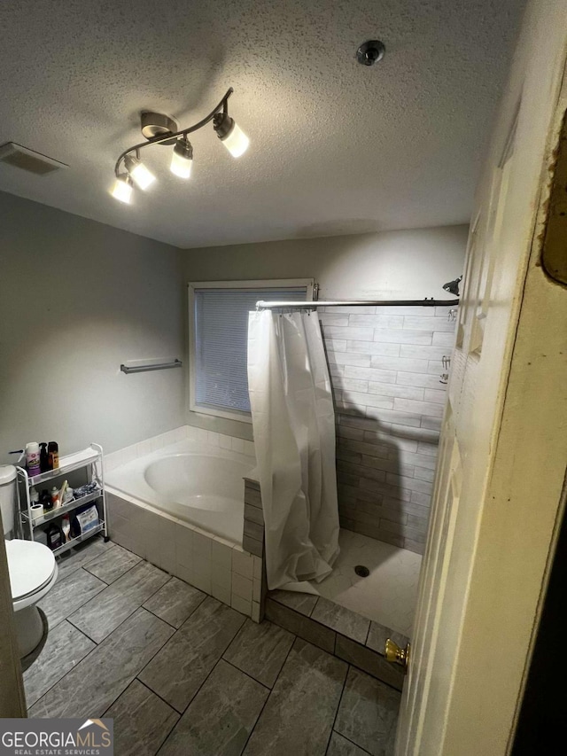 bathroom with a bath, visible vents, wood tiled floor, a shower stall, and toilet