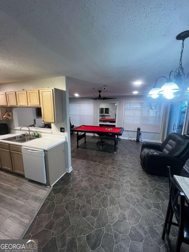 kitchen with pool table, light countertops, white dishwasher, a textured ceiling, and a sink