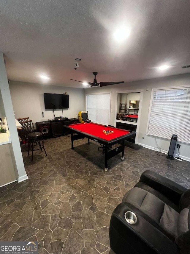 rec room with billiards, a ceiling fan, visible vents, a textured ceiling, and stone flooring