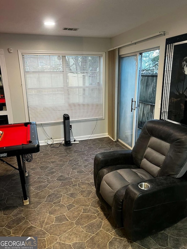 living area with billiards, baseboards, visible vents, and stone finish flooring