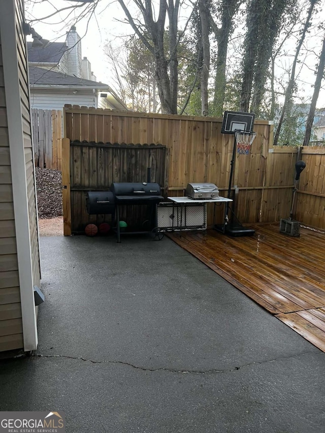 view of patio / terrace featuring a grill and fence