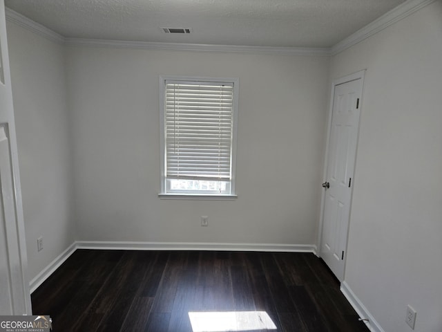 spare room featuring visible vents, crown molding, dark wood-type flooring, baseboards, and a textured ceiling