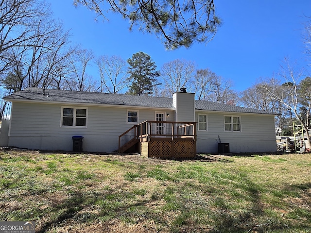 rear view of property with a yard, central AC, a chimney, and a deck