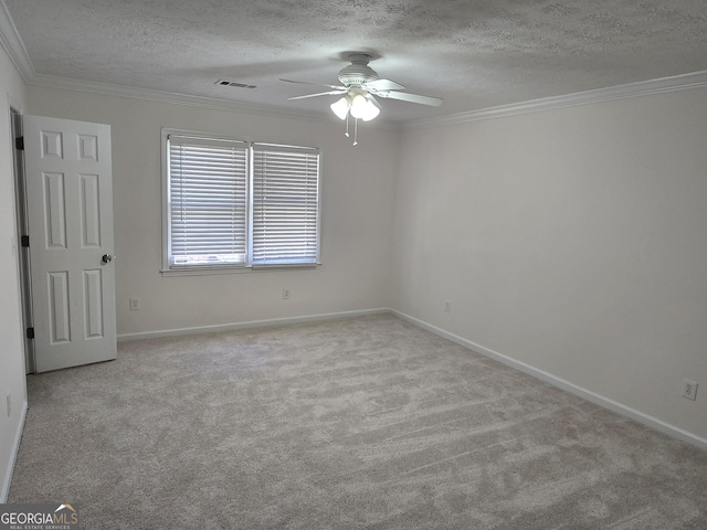 spare room featuring visible vents, a textured ceiling, crown molding, and carpet floors