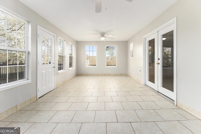 unfurnished sunroom featuring french doors and a ceiling fan