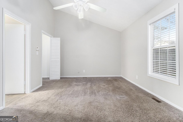 interior space featuring visible vents, ceiling fan, baseboards, and lofted ceiling