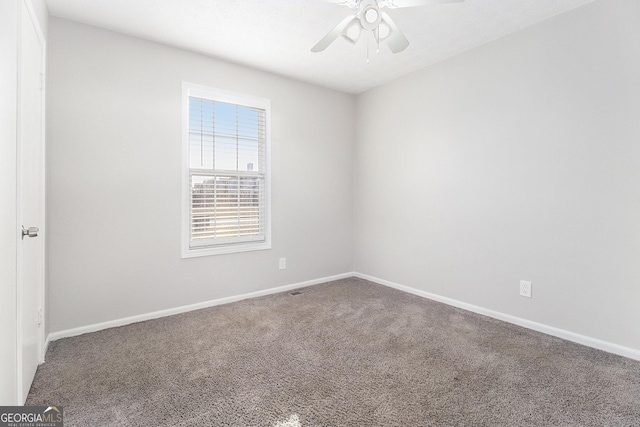 spare room with baseboards, ceiling fan, and carpet flooring