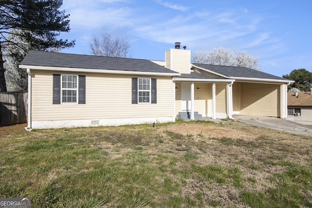 view of front facade with an attached carport, a front lawn, fence, a chimney, and crawl space