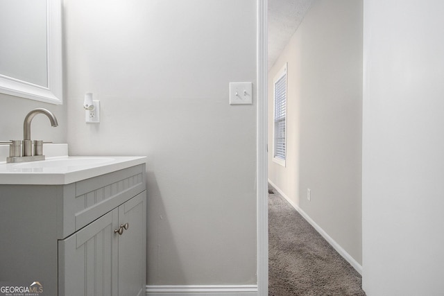 bathroom featuring vanity and baseboards