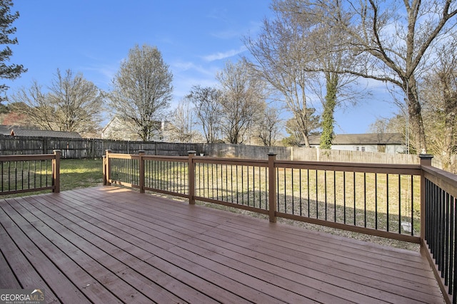 deck featuring a yard and a fenced backyard