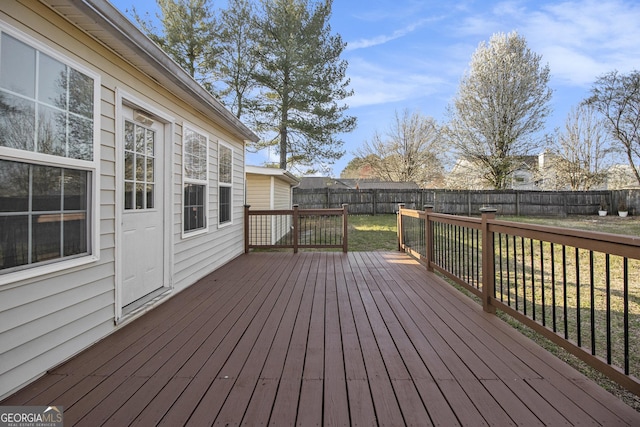 deck featuring a lawn and a fenced backyard