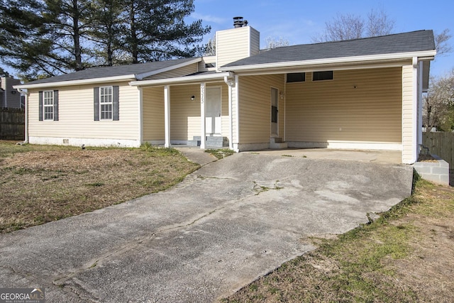 single story home featuring a carport, crawl space, driveway, and fence