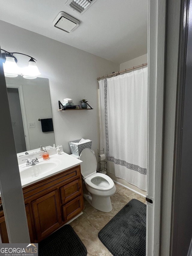 bathroom featuring visible vents, toilet, vanity, and a shower with curtain