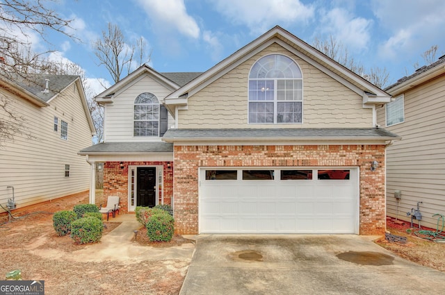 traditional home featuring brick siding, an attached garage, concrete driveway, and roof with shingles