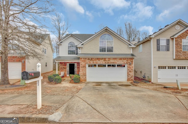 traditional-style home featuring a garage, brick siding, concrete driveway, and a shingled roof