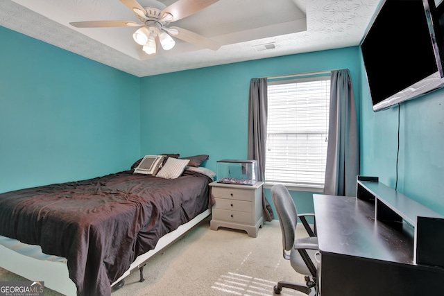 carpeted bedroom with visible vents, multiple windows, a textured ceiling, and ceiling fan